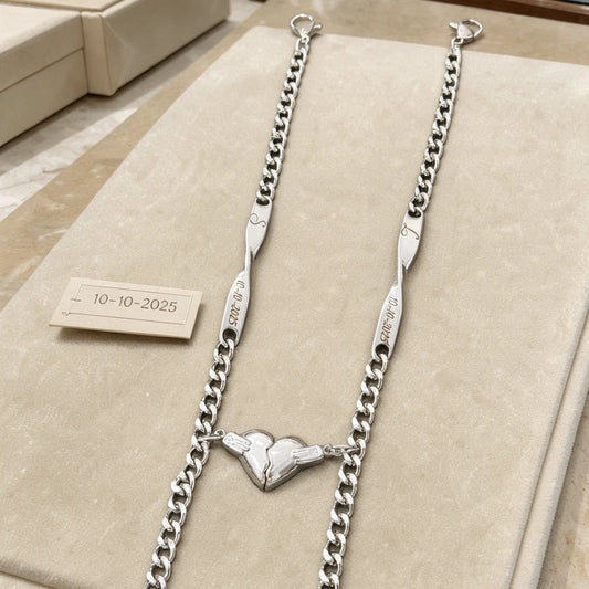 Bracciali Sempre Insieme color argento con iniziali e data, esposti con i due mezzi cuori uniti.